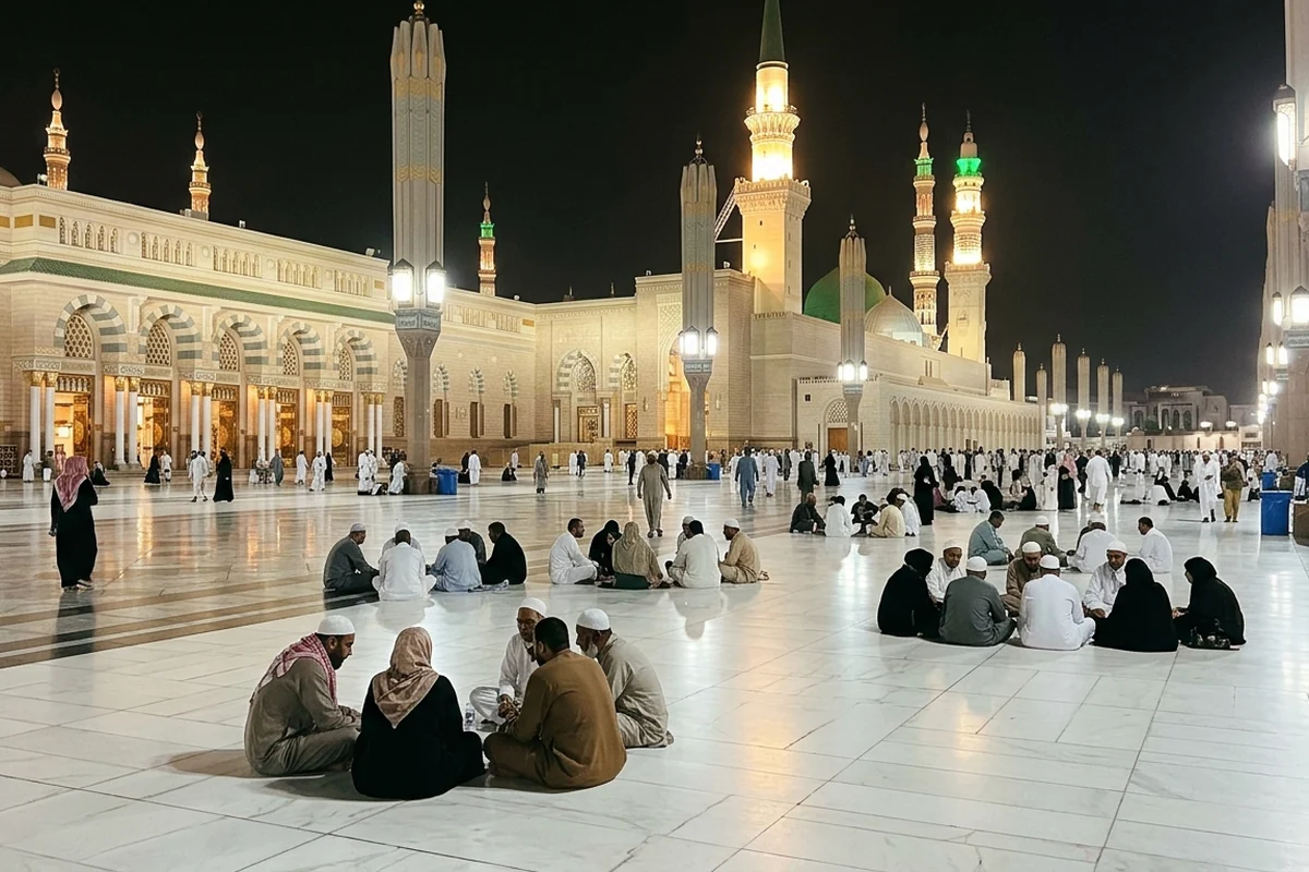 Pilgrims sitting in the courtyard of Masjid an-Nabawi at night