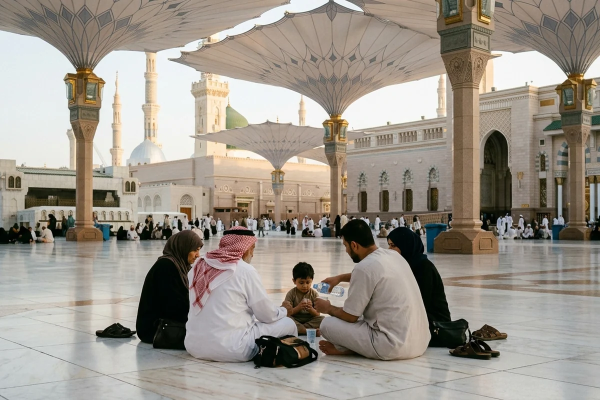 A family sharing water in the shaded courtyard of Masjid an-Nabawi