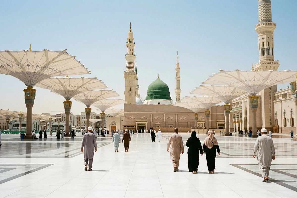 The Green Dome of Masjid an-Nabawi under the open courtyard umbrellas