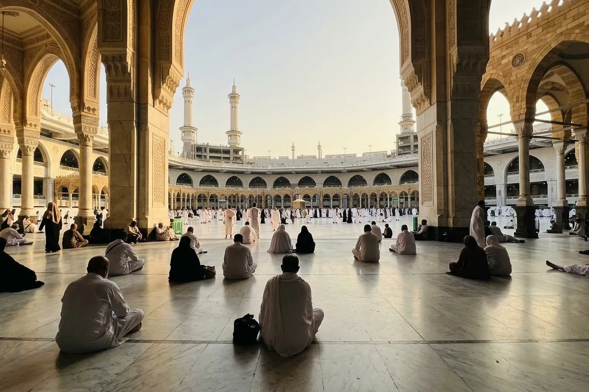 Pilgrims sitting in quiet reflection at Masjid al-Haram
