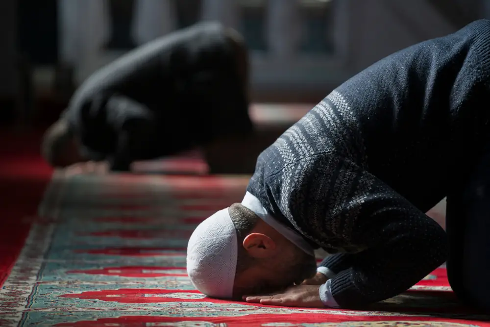 A pilgrim in prostration during prayer