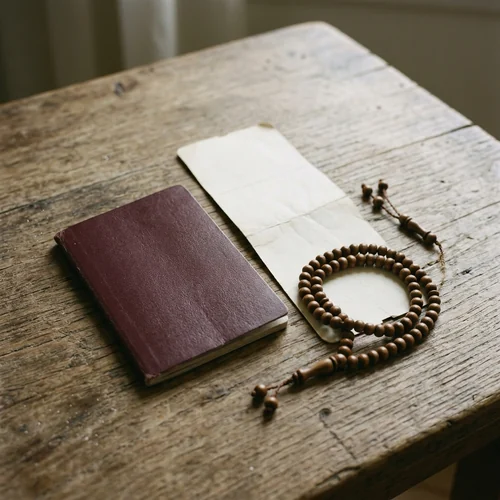 A passport, boarding pass and prayer beads on a table