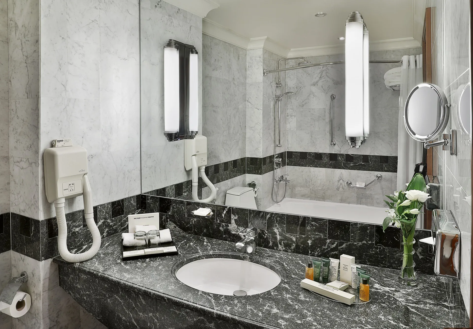 slippers, towels, hair dryer, Combined shower/bathtub at Madinah Hilton Hotel