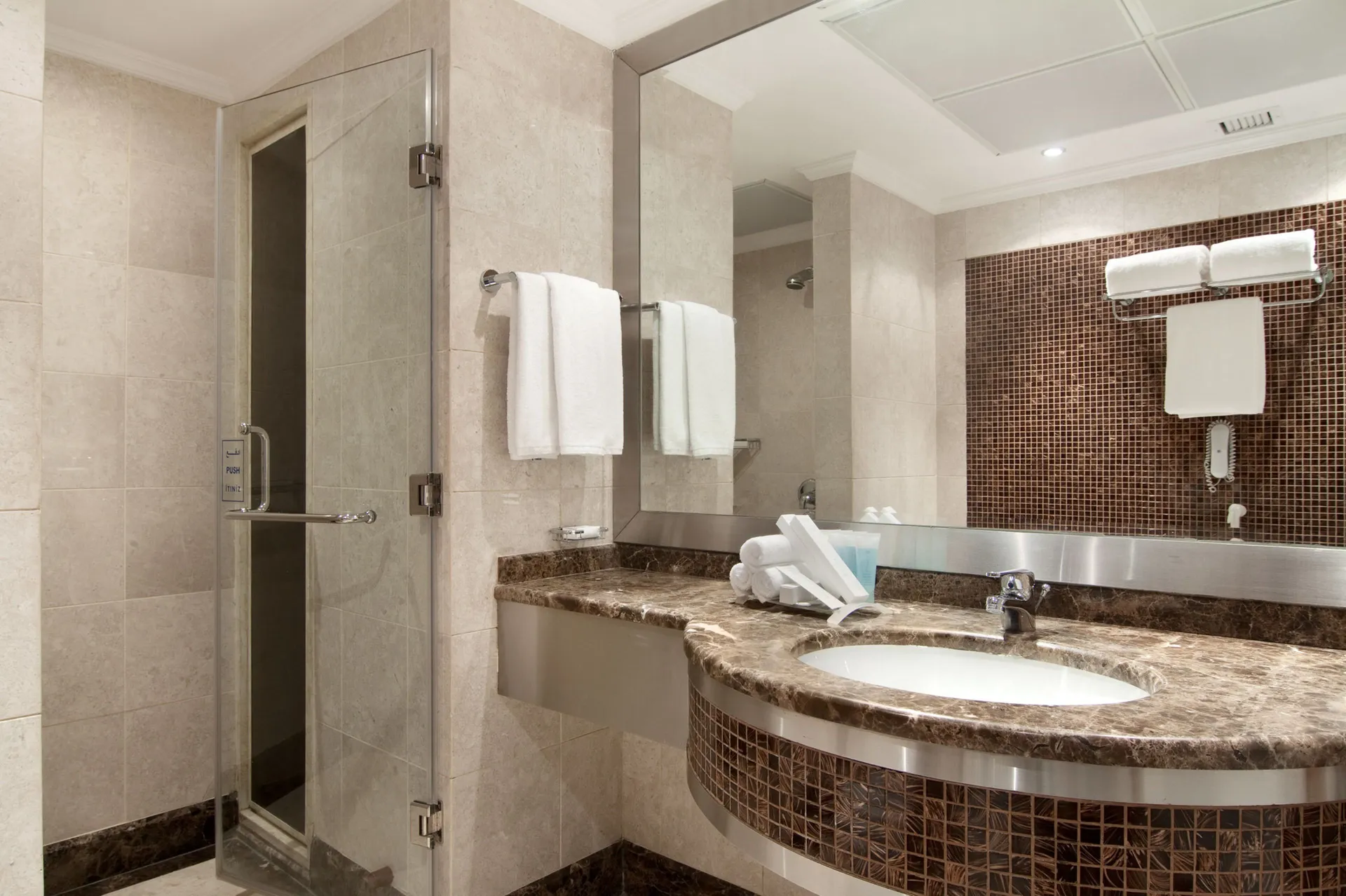 Combined shower/bathtub, free toiletries, slippers, hair dryer at Makkah Towers