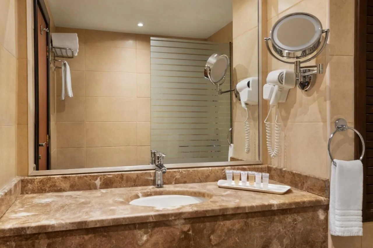 towels, soap, hair dryer, Shower at Ramada Dar Al Fayzeen Hotel Makkah